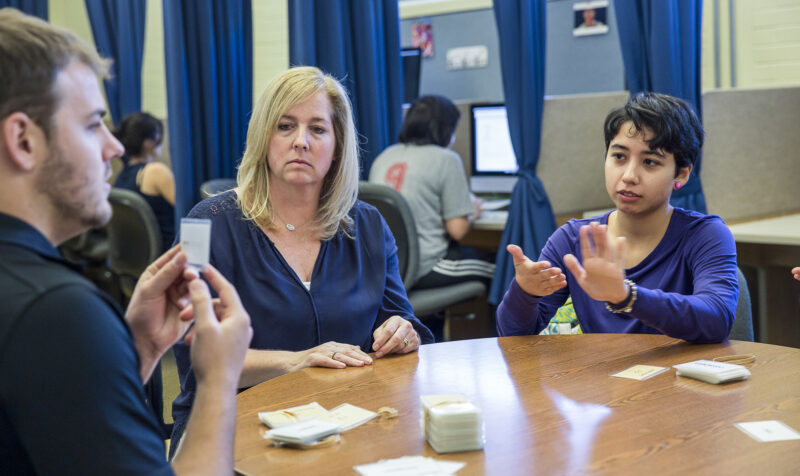 ACC American Sign Language (ASL) students practice in class with cards.