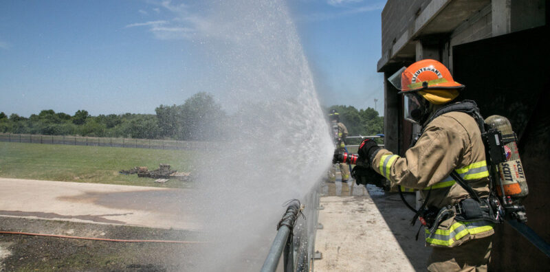 students extinguishing a car fire