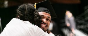 ACC student being hugged at graduation