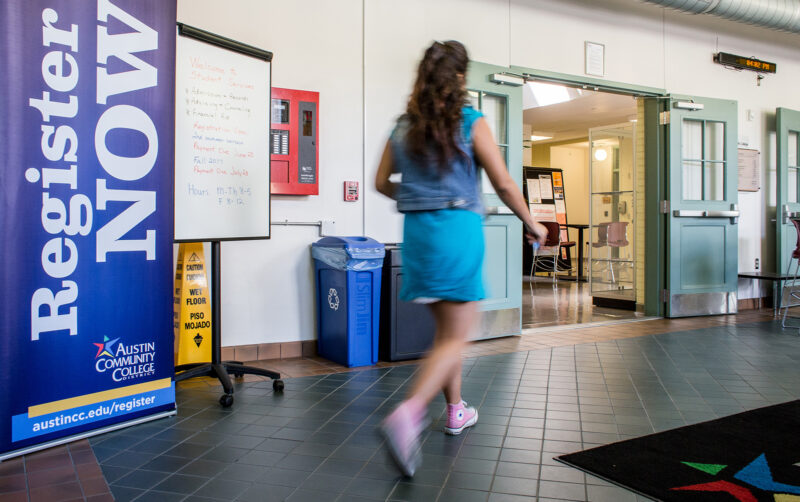 A student walks past registration signage