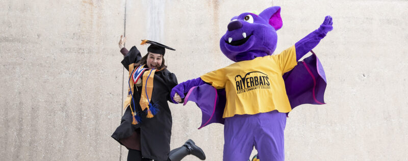 ACC student poses for a portrait with R.B.